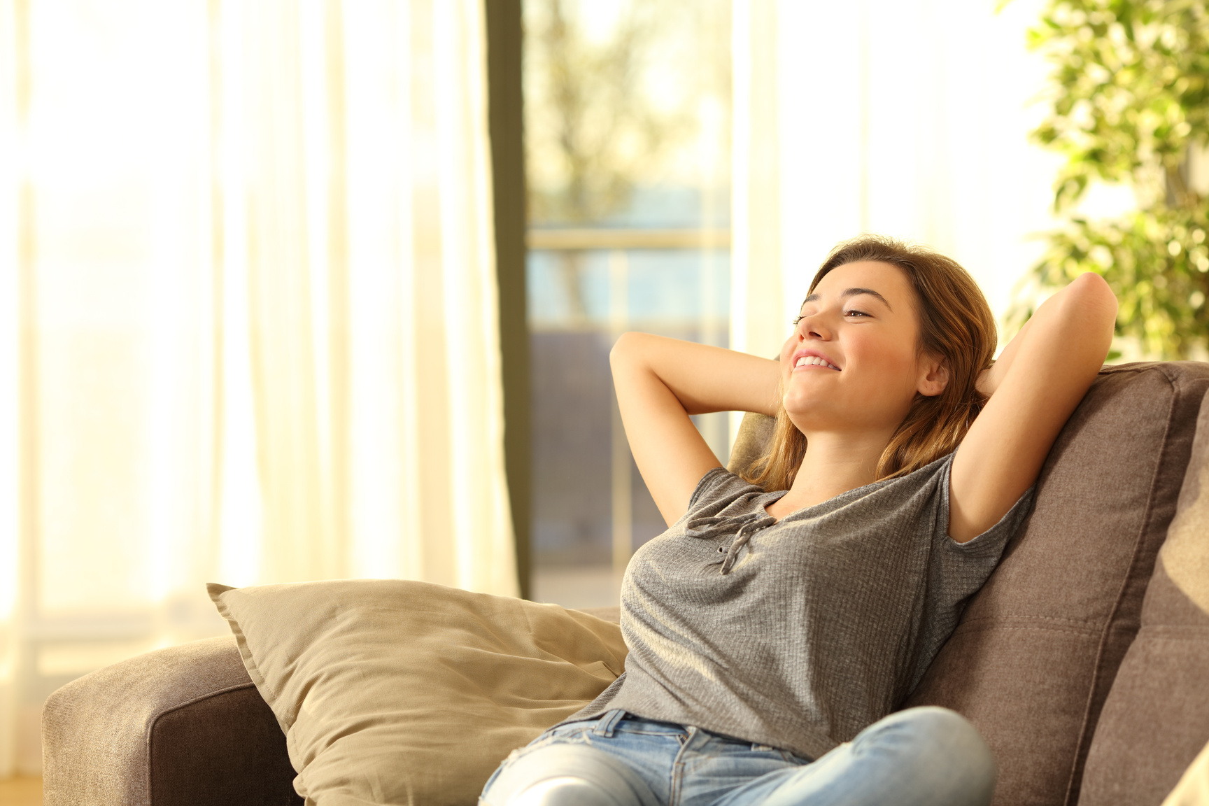 Happy woman resting comfortably at home